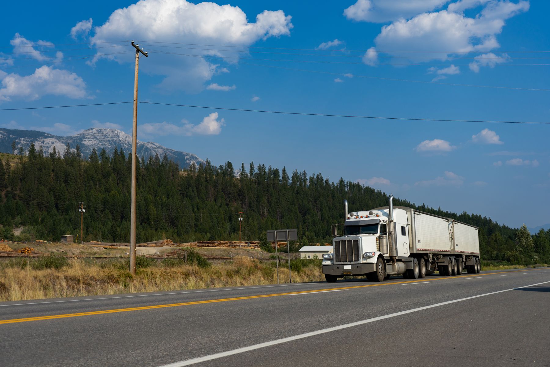 White semi-truck traveling along an open highway