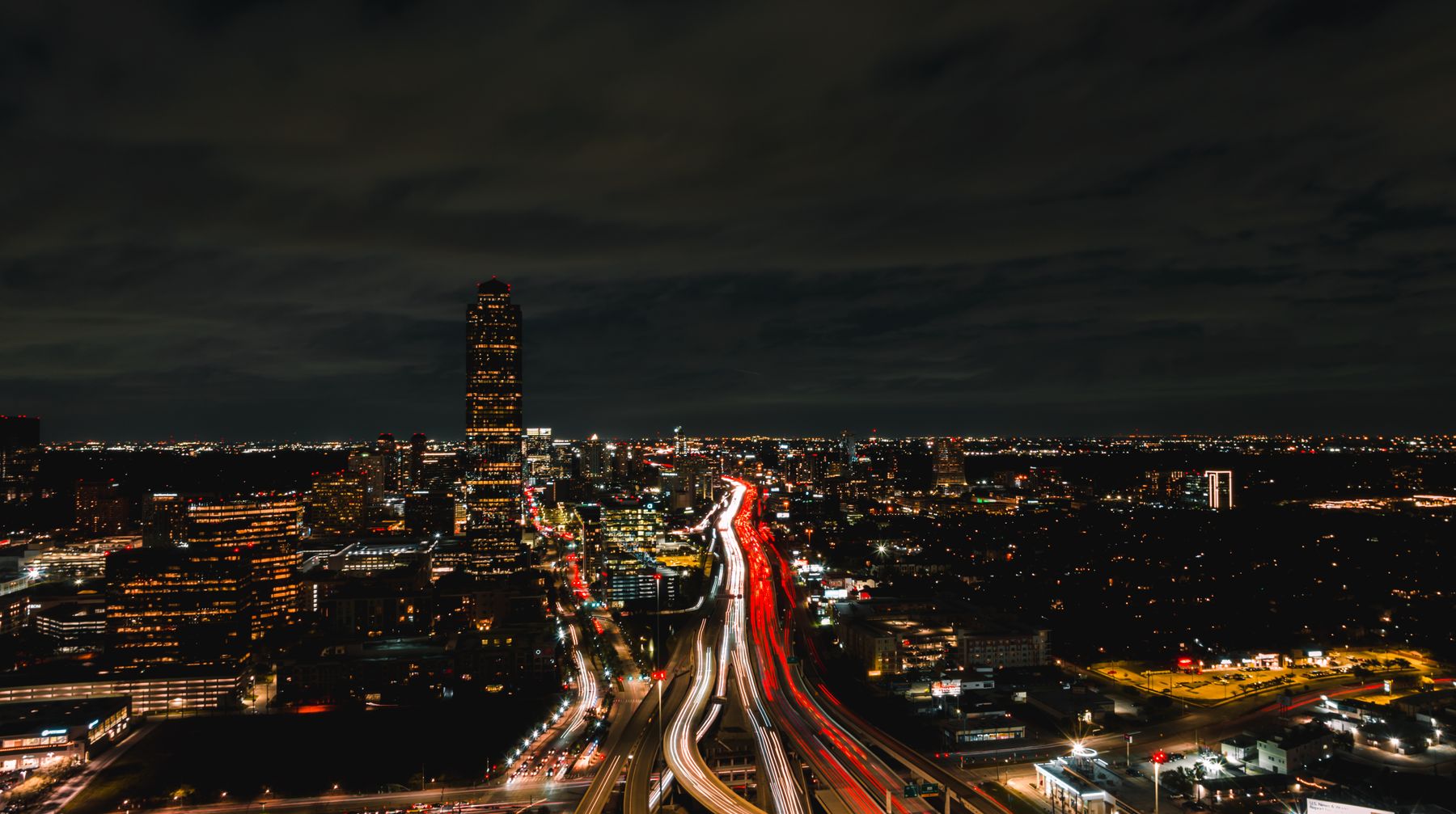 Downtown Houston skyline and highway traffic illuminated at night